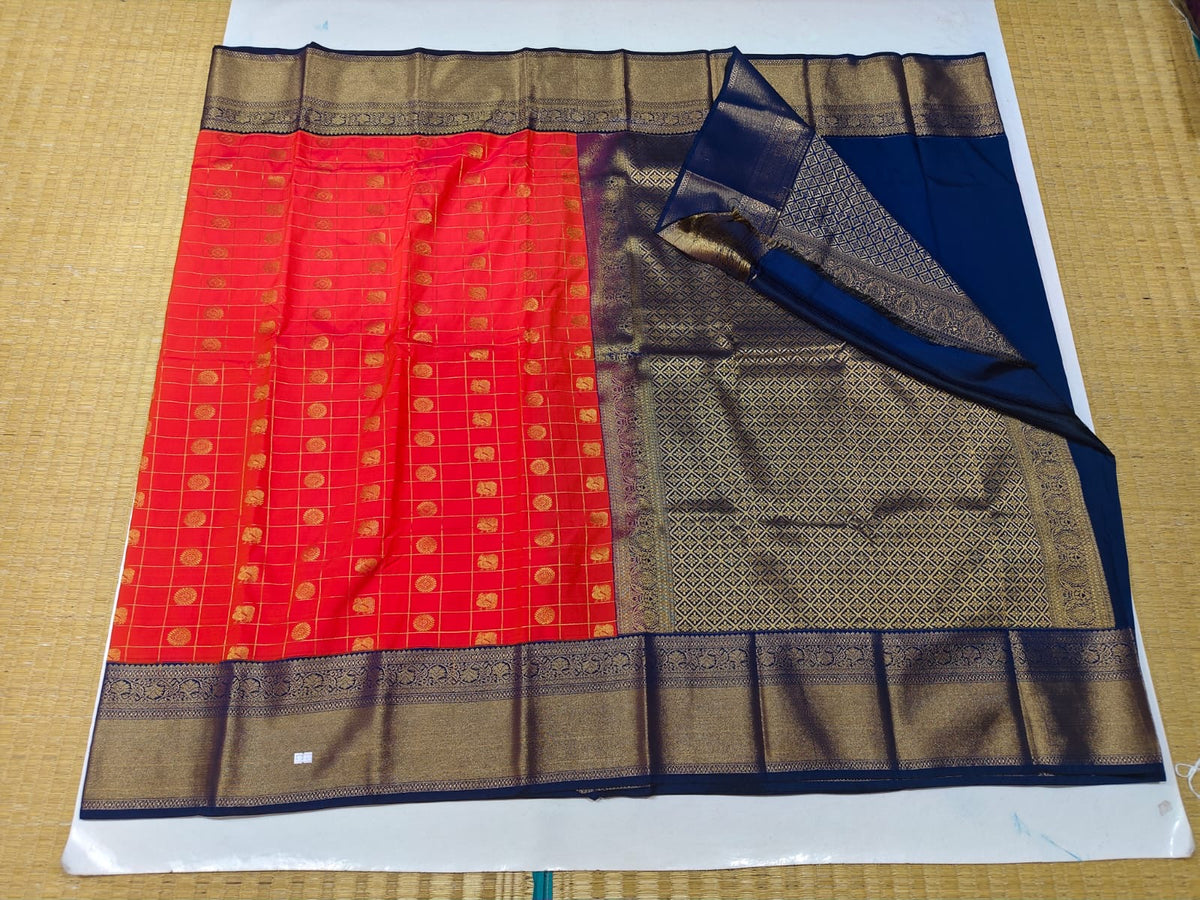 Coral red and navy blue semi-silk festive saree with gold motifs and pallu