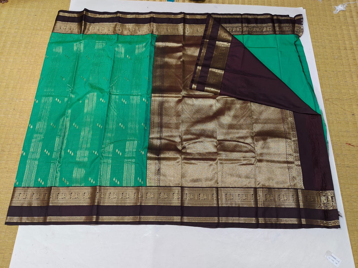 Emerald green and brown gold border festive saree detail